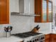 Well-equipped kitchen features stainless steel appliances and modern herringbone backsplash at 4175 S Sidney Ct, Denver, CO 80237