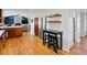 Bright kitchen with hardwood floors, stainless steel appliances, and a view of the living area at 4175 S Sidney Ct, Denver, CO 80237