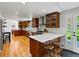 Open kitchen with wood cabinets, stainless appliances, and a breakfast bar with stool seating at 4175 S Sidney Ct, Denver, CO 80237