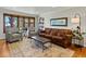 Comfortable living room featuring a bay window, hardwood floors, and stylish decor at 4175 S Sidney Ct, Denver, CO 80237