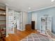 Bright office with hardwood floors, white trim, and a custom-built bookcase at 4175 S Sidney Ct, Denver, CO 80237