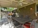 Covered patio with ceiling fan and outdoor dining set for comfortable outdoor living at 4175 S Sidney Ct, Denver, CO 80237