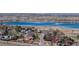 Scenic aerial view of a neighborhood and lake, showcasing the community's natural surroundings at 10553 Xenia Ct, Commerce City, CO 80640