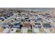 An aerial view showcases a residential neighborhood with lush lawns and picturesque streets at 10553 Xenia Ct, Commerce City, CO 80640