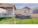 Backyard with a covered patio and landscaping with low maintenance rock groundcover at 10553 Xenia Ct, Commerce City, CO 80640