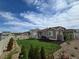 Spacious fenced backyard featuring lush lawn, mature landscaping, and a private outdoor space at 10553 Xenia Ct, Commerce City, CO 80640