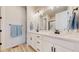 Bathroom featuring dual sinks, a large mirror, and modern black hardware at 10553 Xenia Ct, Commerce City, CO 80640