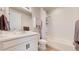 Bright bathroom features a white vanity, updated fixtures, and shower-over-tub, offering a clean and functional design at 10553 Xenia Ct, Commerce City, CO 80640