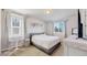 Modern bedroom with carpet flooring, a bed, and bright windows, creating a serene and relaxing space at 10553 Xenia Ct, Commerce City, CO 80640