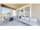 Covered patio with a seating area with mountain views and privacy at 10553 Xenia Ct, Commerce City, CO 80640
