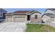 Charming home featuring a three-car garage and well-manicured front yard at 10553 Xenia Ct, Commerce City, CO 80640