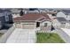 Beautiful one-story home boasting a three-car garage and well-manicured front yard at 10553 Xenia Ct, Commerce City, CO 80640
