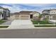 Charming single-story home with well-manicured lawn, three-car garage, and welcoming curb appeal at 10553 Xenia Ct, Commerce City, CO 80640