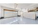 Spacious two car garage with a clean epoxy floor and ample space at 10553 Xenia Ct, Commerce City, CO 80640