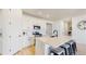 Modern kitchen features white cabinets, stainless steel appliances, and a quartz countertop island with bar stool seating at 10553 Xenia Ct, Commerce City, CO 80640