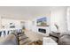 Modern living room with fireplace and open layout to the beautiful kitchen area at 10553 Xenia Ct, Commerce City, CO 80640