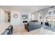 Bright living room featuring a fireplace and an open layout to the beautiful kitchen at 10553 Xenia Ct, Commerce City, CO 80640