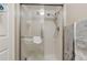 Bathroom shower with glass sliding doors and white tile at 13631 E Marina Dr # 502, Aurora, CO 80014