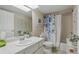 Well-lit bathroom featuring a vanity with ample storage and a shower/tub combo with floral curtain at 13631 E Marina Dr # 502, Aurora, CO 80014