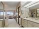 Bathroom with double vanity and view into bedroom at 13631 E Marina Dr # 502, Aurora, CO 80014