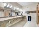 Large bathroom with multiple sinks, granite countertops, and neutral tile flooring at 13631 E Marina Dr # 502, Aurora, CO 80014
