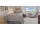 Cozy bedroom featuring a large window for natural light, bedside tables, and neutral decor at 13631 E Marina Dr # 502, Aurora, CO 80014