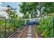 Beautiful garden with raised beds and a stone pathway amidst lush greenery at 13631 E Marina Dr # 502, Aurora, CO 80014