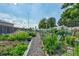 Lush garden with flowers, vegetables, and a gravel pathway under a sunny sky at 13631 E Marina Dr # 502, Aurora, CO 80014