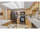 Bright kitchen boasts stainless steel appliances, light wood cabinets, and ample counter space at 13631 E Marina Dr # 502, Aurora, CO 80014