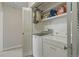 Convenient laundry area featuring a washer, dryer, and storage shelves for supplies at 13631 E Marina Dr # 502, Aurora, CO 80014