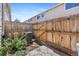 Cozy fenced-in backyard featuring a small patio, shrubs, and the home's air conditioning unit at 8915 Field St # 116, Broomfield, CO 80021