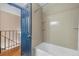 Bathroom featuring tiled shower and blue door at 8915 Field St # 116, Broomfield, CO 80021