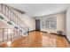 Inviting entryway with hardwood floors and staircase featuring iron railing to the upper level at 8915 Field St # 116, Broomfield, CO 80021
