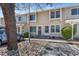 Charming townhome featuring a welcoming entrance and well-maintained landscaping with mature trees at 8915 Field St # 116, Broomfield, CO 80021
