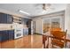 Kitchen area featuring modern appliances, wood cabinets, and a dining area with sliding glass door at 8915 Field St # 116, Broomfield, CO 80021
