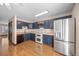 Bright kitchen with wood cabinets, stainless steel appliances, and hardwood floors at 8915 Field St # 116, Broomfield, CO 80021