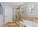 A bright bathroom showcasing soaking tub and stand up shower with seamless glass at 10700 Addison Ct, Highlands Ranch, CO 80126