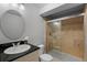 Bathroom featuring tiled shower, vanity with black countertop and a mirror at 10700 Addison Ct, Highlands Ranch, CO 80126