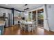 Bright dining area features hardwood floors, a modern light fixture and sliding glass doors to an outdoor patio at 10700 Addison Ct, Highlands Ranch, CO 80126