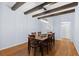 Dining room featuring wood floors, a wooden table with seating for eight, and a modern light fixture at 10700 Addison Ct, Highlands Ranch, CO 80126