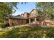 Charming two-story home with brick accents, covered porch, and manicured lawn at 10700 Addison Ct, Highlands Ranch, CO 80126