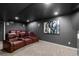 Home theater with plush seating, dark walls, and ceiling for an immersive experience at 10700 Addison Ct, Highlands Ranch, CO 80126