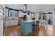 Open kitchen with stainless steel appliances, a center island, custom cabinets, and a view to the dining area at 10700 Addison Ct, Highlands Ranch, CO 80126