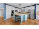 Spacious kitchen boasts stainless steel appliances, granite countertops, white cabinets, and a charming center island at 10700 Addison Ct, Highlands Ranch, CO 80126