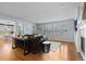 Spacious living room with wood floors, large windows, and open to dining and kitchen at 10700 Addison Ct, Highlands Ranch, CO 80126