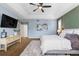 A comfortably furnished main bedroom features a tray ceiling with fan, and a decorative accent wall at 10700 Addison Ct, Highlands Ranch, CO 80126