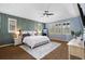 A spacious main bedroom featuring tray ceiling, a decorative accent wall, and large windows providing ample natural light at 10700 Addison Ct, Highlands Ranch, CO 80126