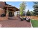 Spacious outdoor patio with comfortable seating, a fire pit, and a built-in grill at 10700 Addison Ct, Highlands Ranch, CO 80126