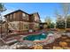Inviting backyard pool and spa with brick patio and outdoor seating area at 10700 Addison Ct, Highlands Ranch, CO 80126