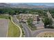 Aerial view of a commercial building surrounded by trees, streets, and nearby parking at 615 24Th St # 103, Golden, CO 80401